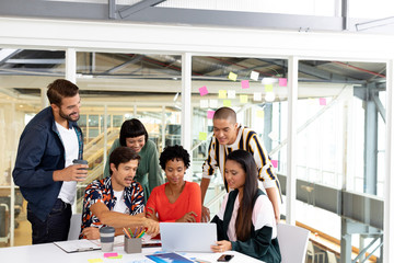 Business people discussing over laptop in the conference room