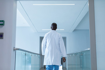Male doctor walking in the corridor at hospital