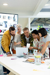Business people discussing over laptop in the conference room
