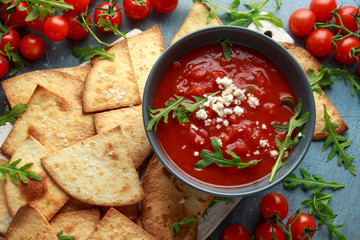 Grilled corn tortilla with sea salt flakes, spicy tomato salsa sauce and feta cheese