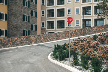 Beautiful view of a modern residential area or district. Residential buildings and the road with traffic stop sign