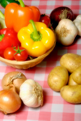 various kinds of vegetables like peppers, tomatoes, zucchini, potatoes, garlic and onion in rustic style