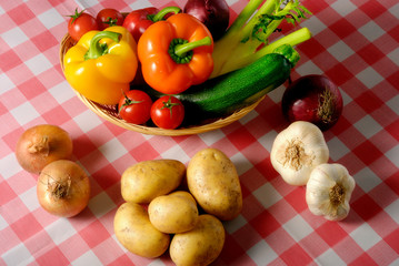 various kinds of vegetables like peppers, tomatoes, zucchini, potatoes, garlic and onion in rustic style 