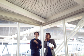 Male and female architects interacting with each other in office