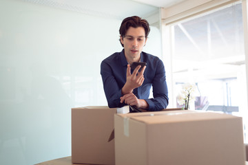 Male executive talking on mobile phone in office