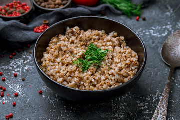 boiled buckwheat porridge on black bowl