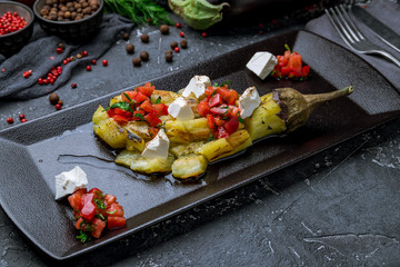 baked eggplant on plate on black plate