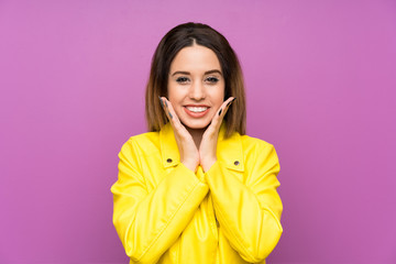Young woman over purple background with surprise facial expression