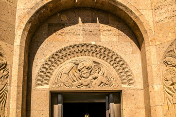 Stone slab with carved by the Mother of God with  baby over entrance under the arched portal in the Saints Martyr church in the village Teghenik of Armenia