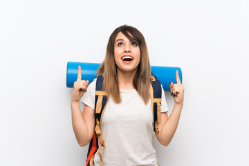 Young traveler woman over white background pointing up a great idea