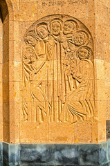 Images of Holy Martyrs are carved on the wall of the oval portal at the entrance to the Church of Holy Martyrs in the village of Teghenik  in Armenia