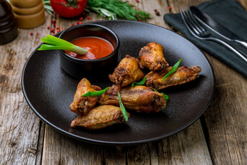 Buffalo chicken wings on black plate