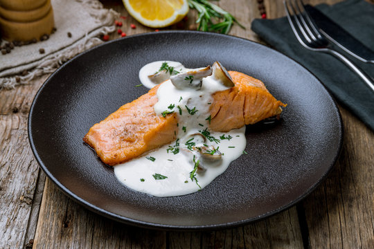 Salmon Steak On The Grill On Black Plate