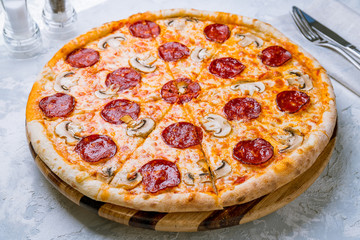 Pepperoni pizza with mushrooms on plate
