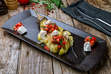 baked eggplant on plate on black plate