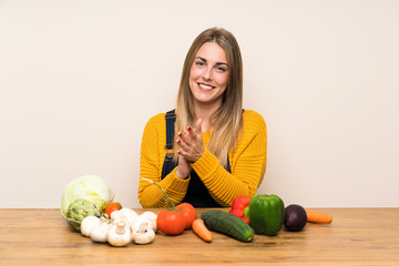Woman with lots of vegetables applauding