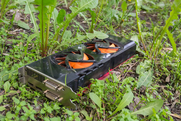 Computer video card, thrown out due to breakdown on the street in the grass