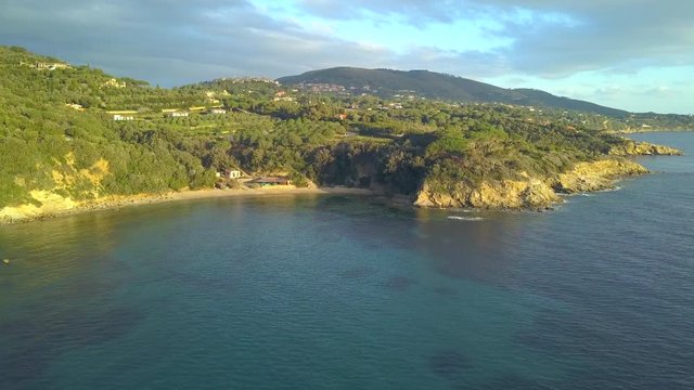 Aerial Drone Shot Flying Towards The Beautiful Spiaggia Zuccale Beach at Sunset in Elba, Italy
