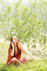 Obraz premium Woman with Headphones Outdoors