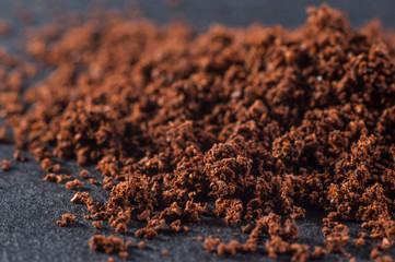 Fresh ground brewed coffee on a dark background, close-up