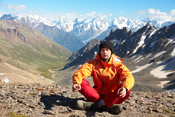 Fototapeta premium man with backpack hiking in the mountains