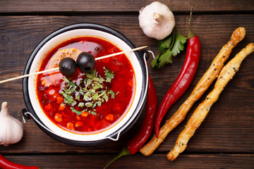 Traditional Ukrainian meat soup solyanka in metal bowl. Nourishing and delicious national food, ethnic restaurant menu
