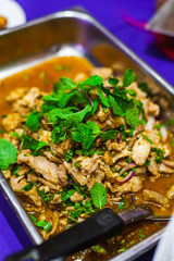 Slide Grilled Pork salad with Spicy and Herb or Namtok a Famous Thai Food in the Tray.
