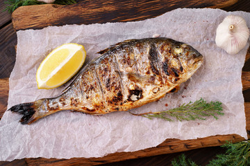 grill pub and fish restaurant menu, proper nutrition, seafood, vegetarian, pescetarian. grilled dorado fish with lemon and herbs