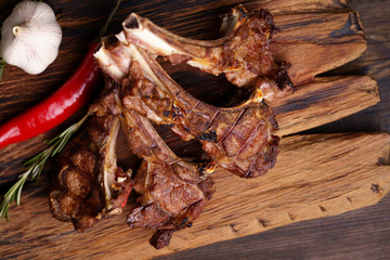 meat and grill restaurant menu. spicy grilled lamb ribs loin on serving board. delicious chef's meals
