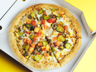 Pizza in a box on a yellow background