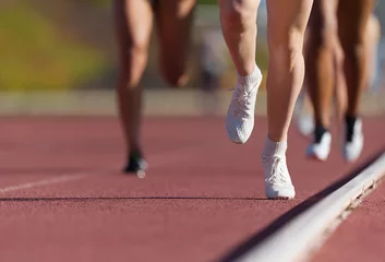 Poster Group of athletes sprinters run speed on track of stadium © pavel1964