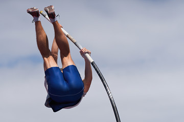 Athlete pole vault with a sky