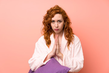 Redhead woman in dressing gown pleading