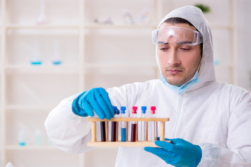 Young male chemist working in the lab 