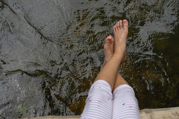 Children feet playing in the water
