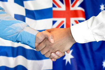 Business handshake on the background of two flags. Men handshake on the background of the Greece and Australia flag. Support concept