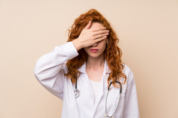 Redhead doctor woman covering eyes by hands