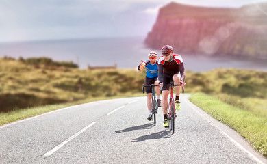 Cyclists out racing along country lanes near the coast in the United Kingdom