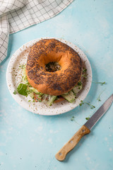 Fresh bagel with bacon, cheese and cucumber