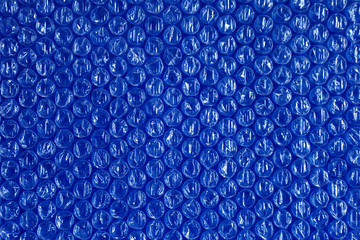 plastic background texture cellophane wrapping packing wrap packet bead ball brilliant blue sky...