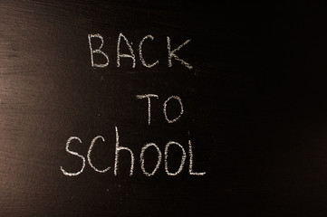 Back to school, the concept of parenting. The inscription on the blackboard with white chalk. Place for text. Copy space. 