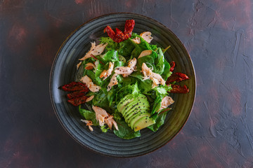 Salad with salmon, avocado and sun dried tomatoes