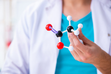Young male chemist working in the lab 