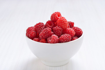 Raspberries in white bowl