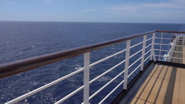 Railing of cruise ship showing wooden deck