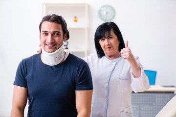 Young male patient visiting aged female doctor 