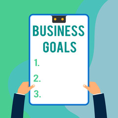 Conceptual hand writing showing Business Goals. Concept meaning Expectation to accomplish over a specific period of time Two executive male hands electronic device geometrical background