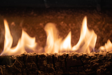close up of wooden log burning fire flames in wintertime