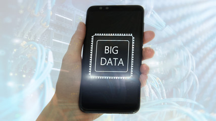 Woman Hand holding mobile phone. Server room background. Inscription on a virtual screen: Big Data. Double exposure.