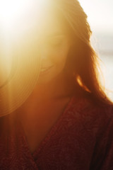 A beautyful woman feeling free meeting sun near the sea